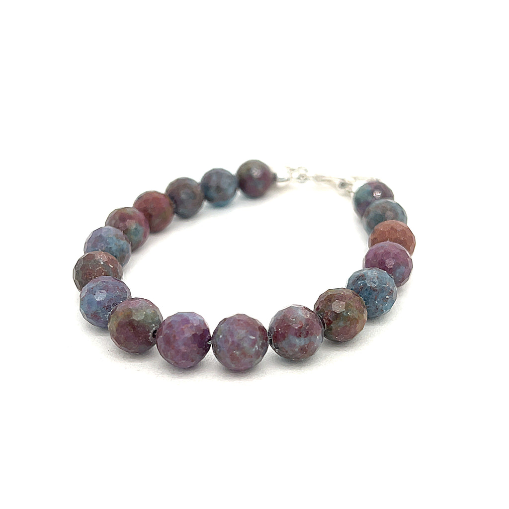 Ruby Kyanite gemstone bracelet with sterling silver toggle clasp on white background front and slight left angel overview. 