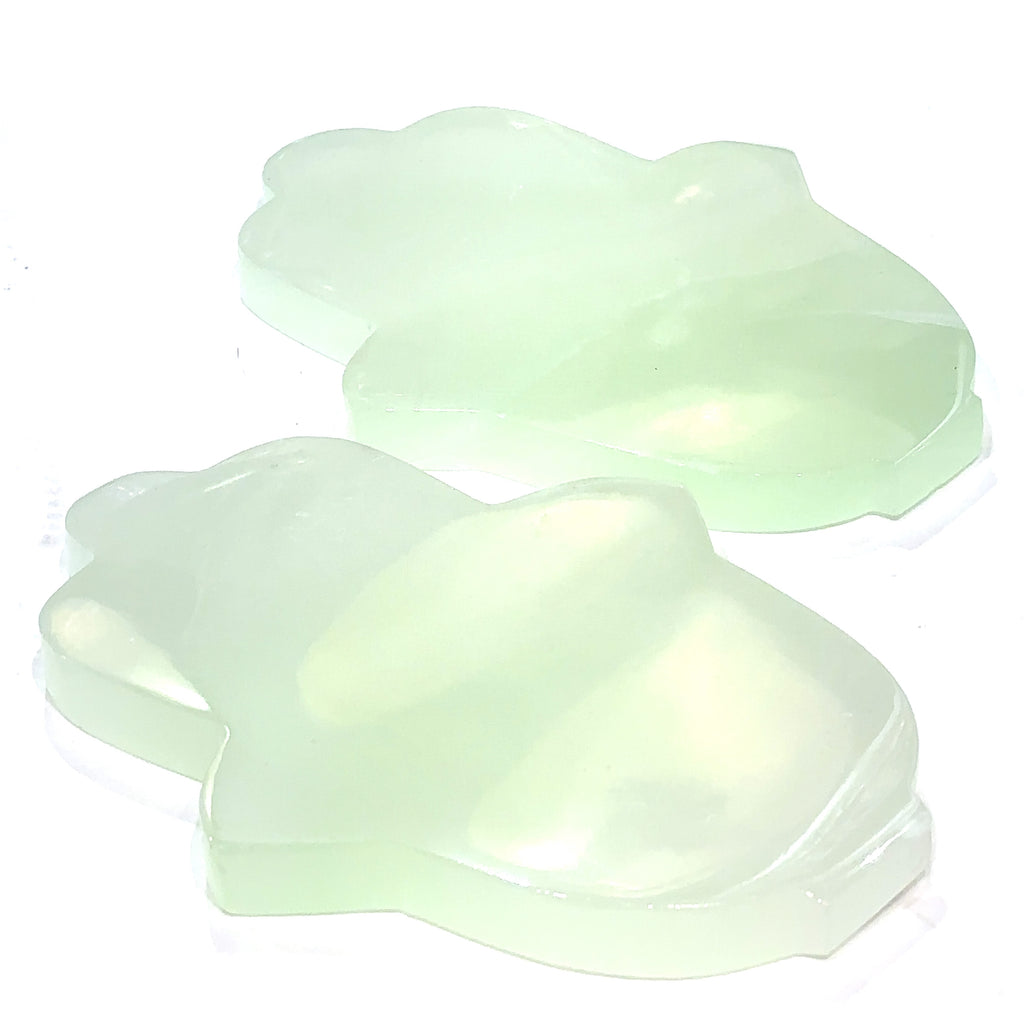 Set #2 Two pistachio calcite humza gemstone carvings with a pale green to white color and varying shades of brown, displayed on a white background front overview