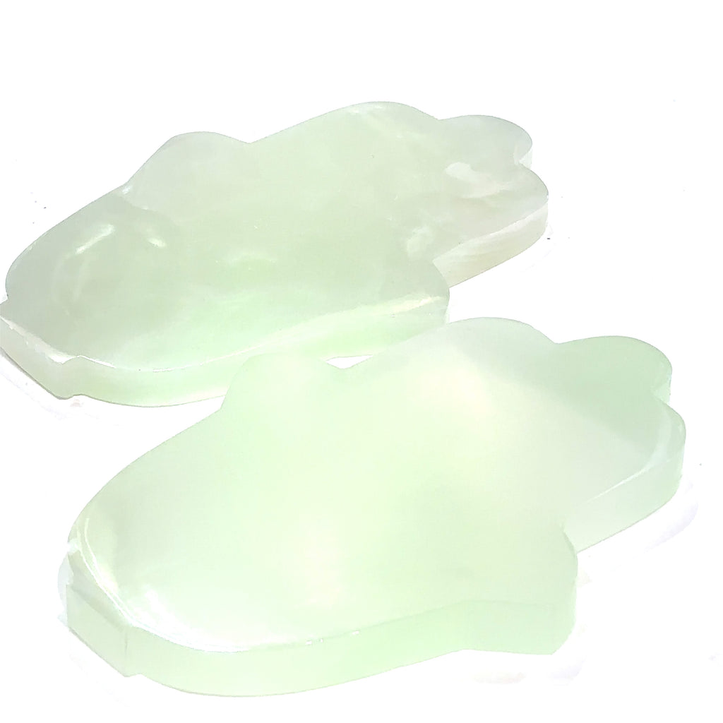 Set #3 Two pistachio calcite humza gemstone carvings with a pale green to white color and varying shades of brown, displayed on a white background front overview