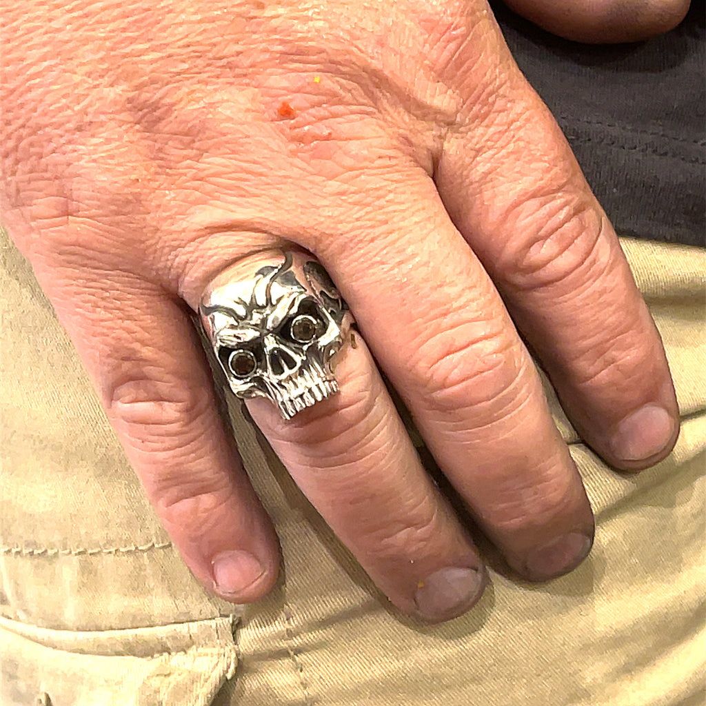Smoky quartz gemstone skull ring — handcrafted statement piece  on a male models finer on a white background front view