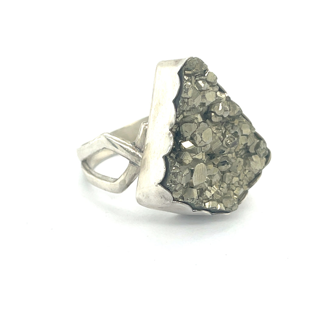 Statement Pyrite ring in scalloped bezel setting — handmade gemstone jewelry on a white background front slight right angle view. 