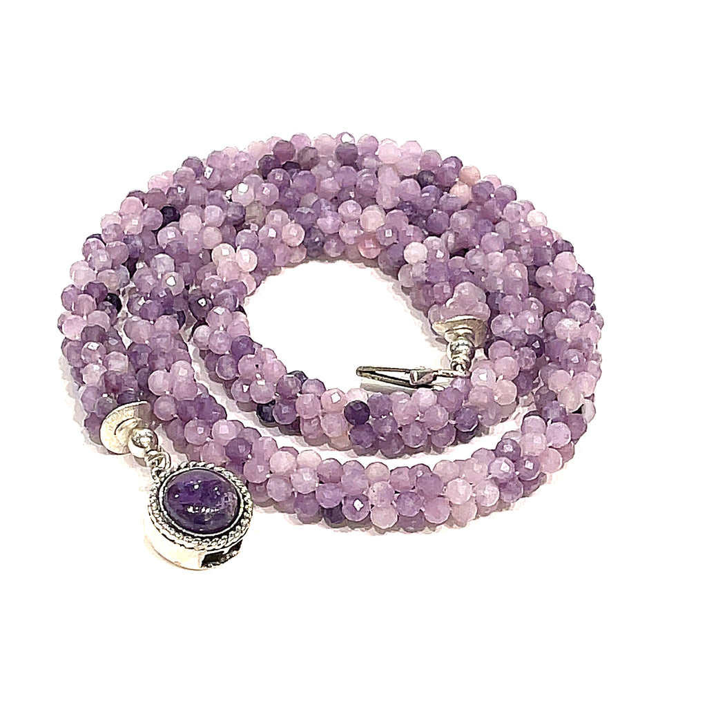 Sugilite crocheted gemstone necklace on a white background, spiral, front, overview. 