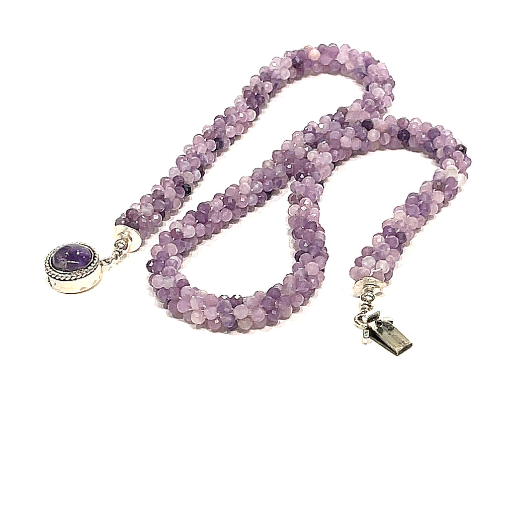 Sugilite crocheted gemstone necklace on a white background, zigzag lay out, front, close-up overview. 