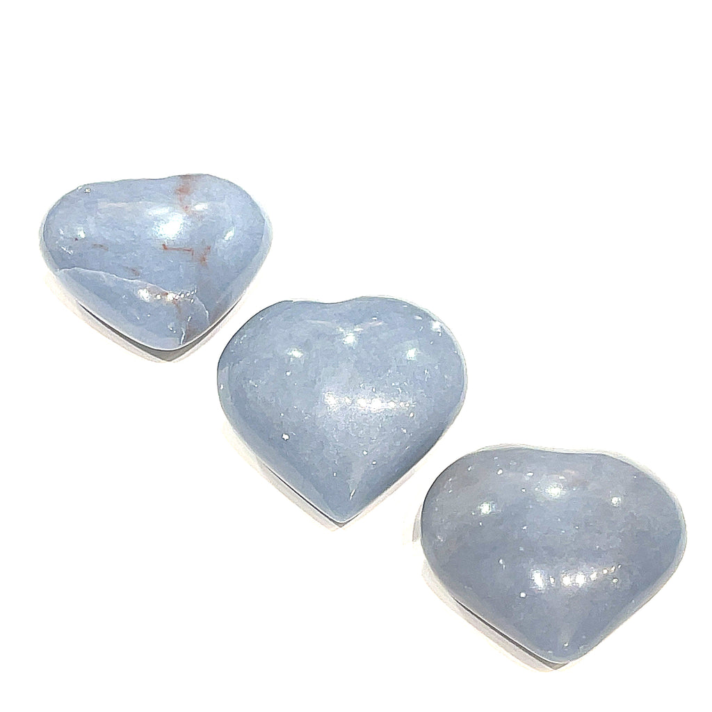 Three Angelite gemstone hearts arranged on a white background, front and center view.