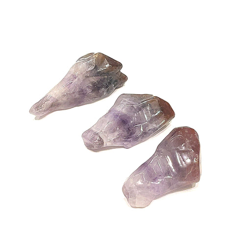 Three Auralite-23 tumbled gemstones are displayed on a white background, front overview.