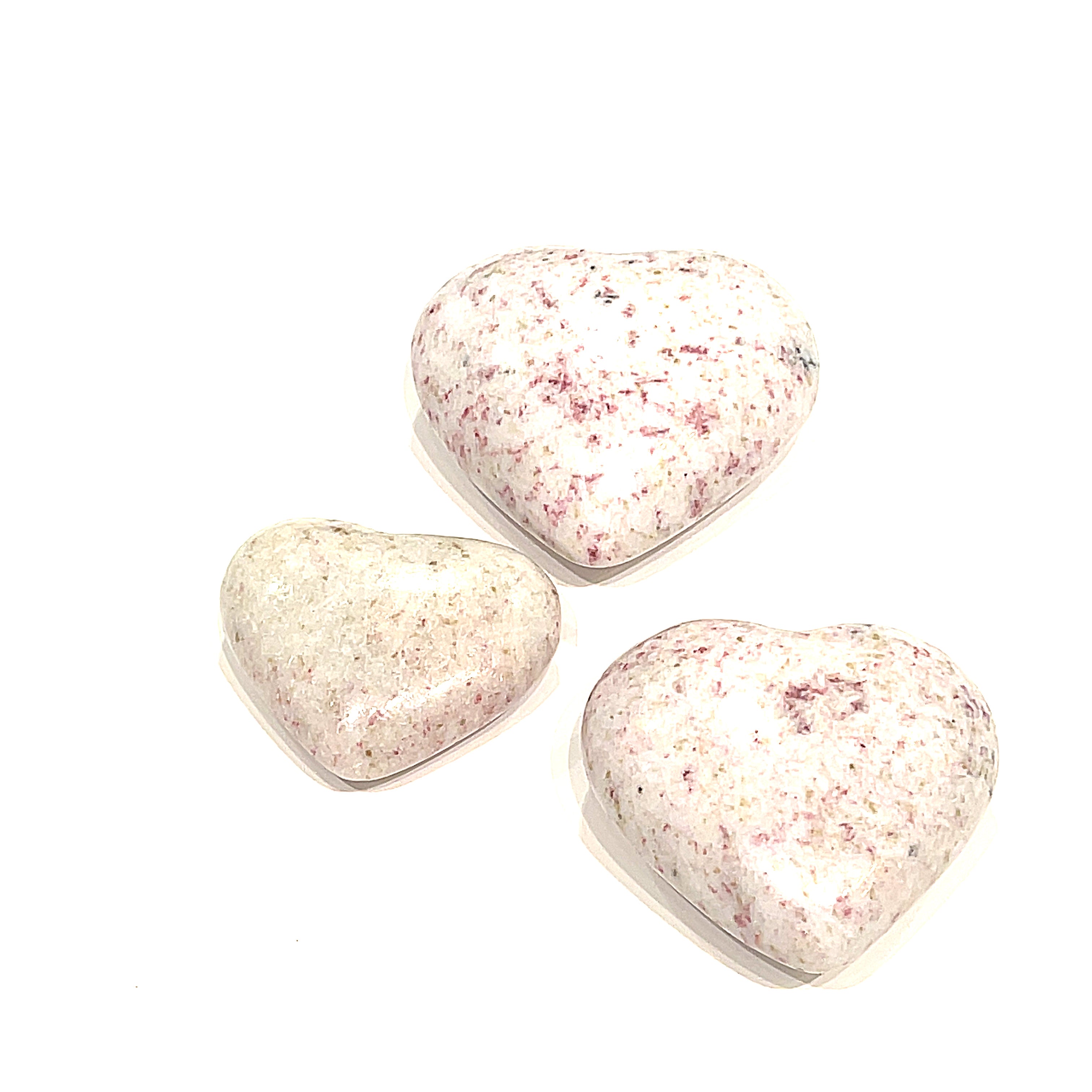 Three Cinnabar gemstone hearts displayed on a white background front, center, overview. 