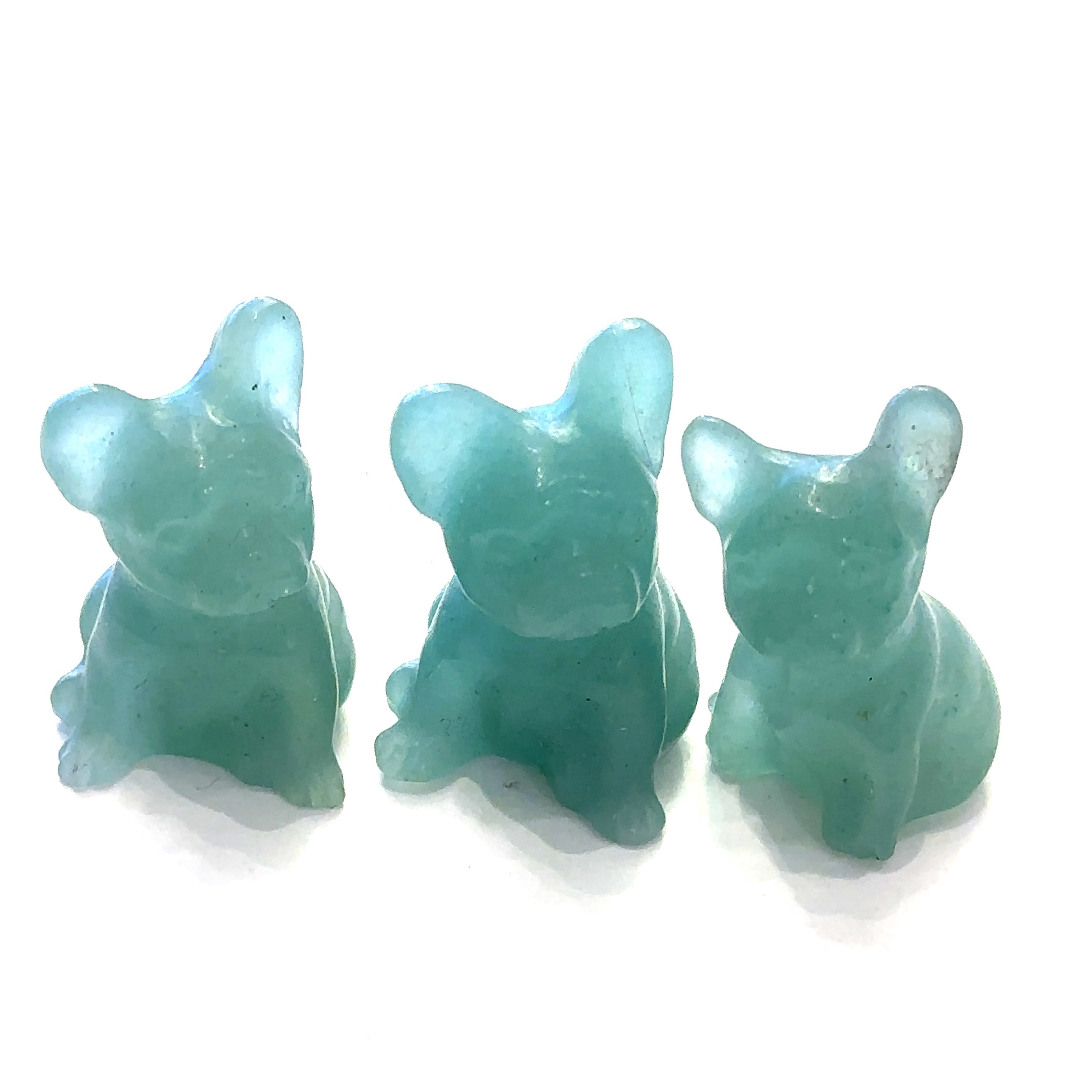 Three Green Aventurine Bull Dogs gemstone carving on white background, front view. 