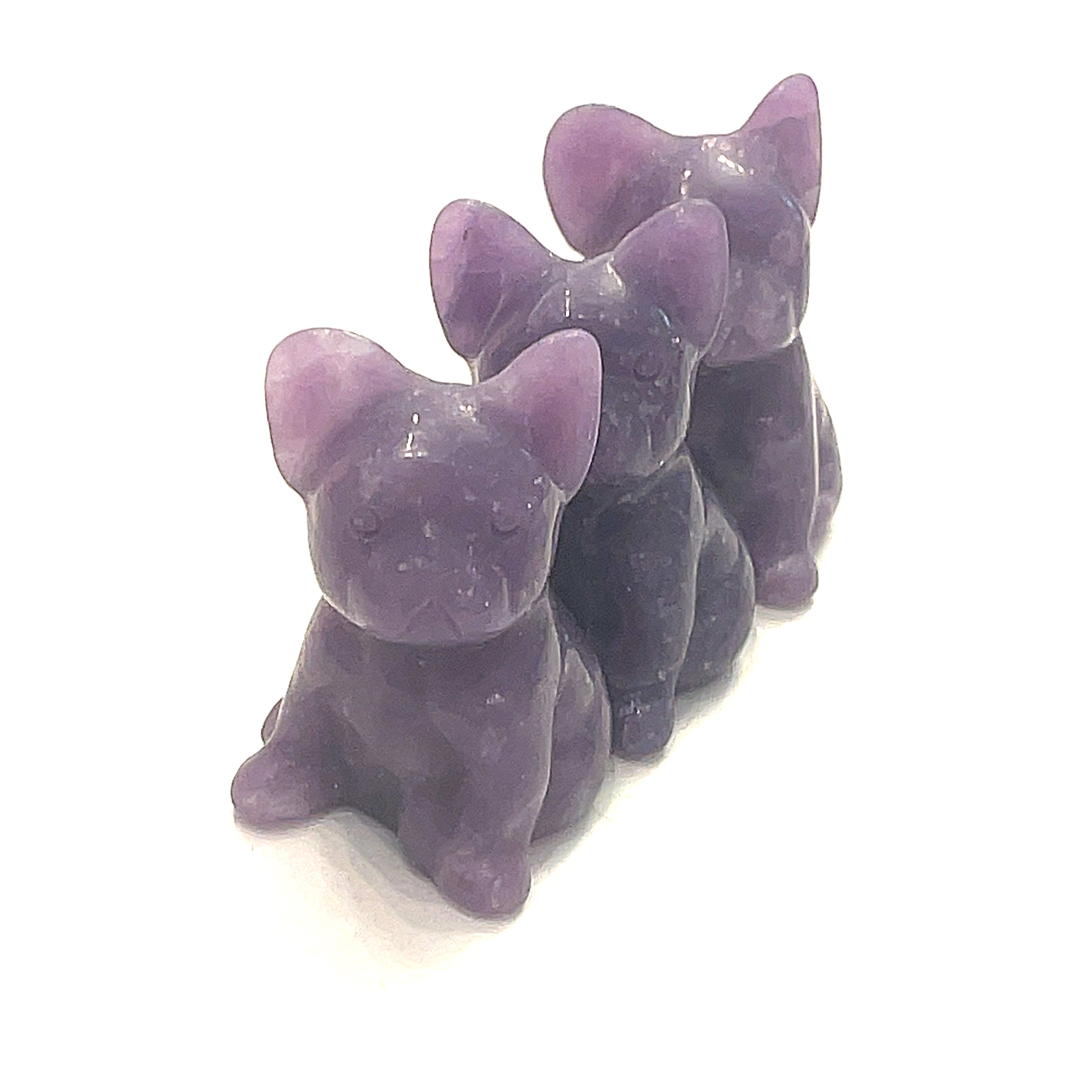 Three Lepidolite Bull Dogs gemstone carving on white background, front view. 