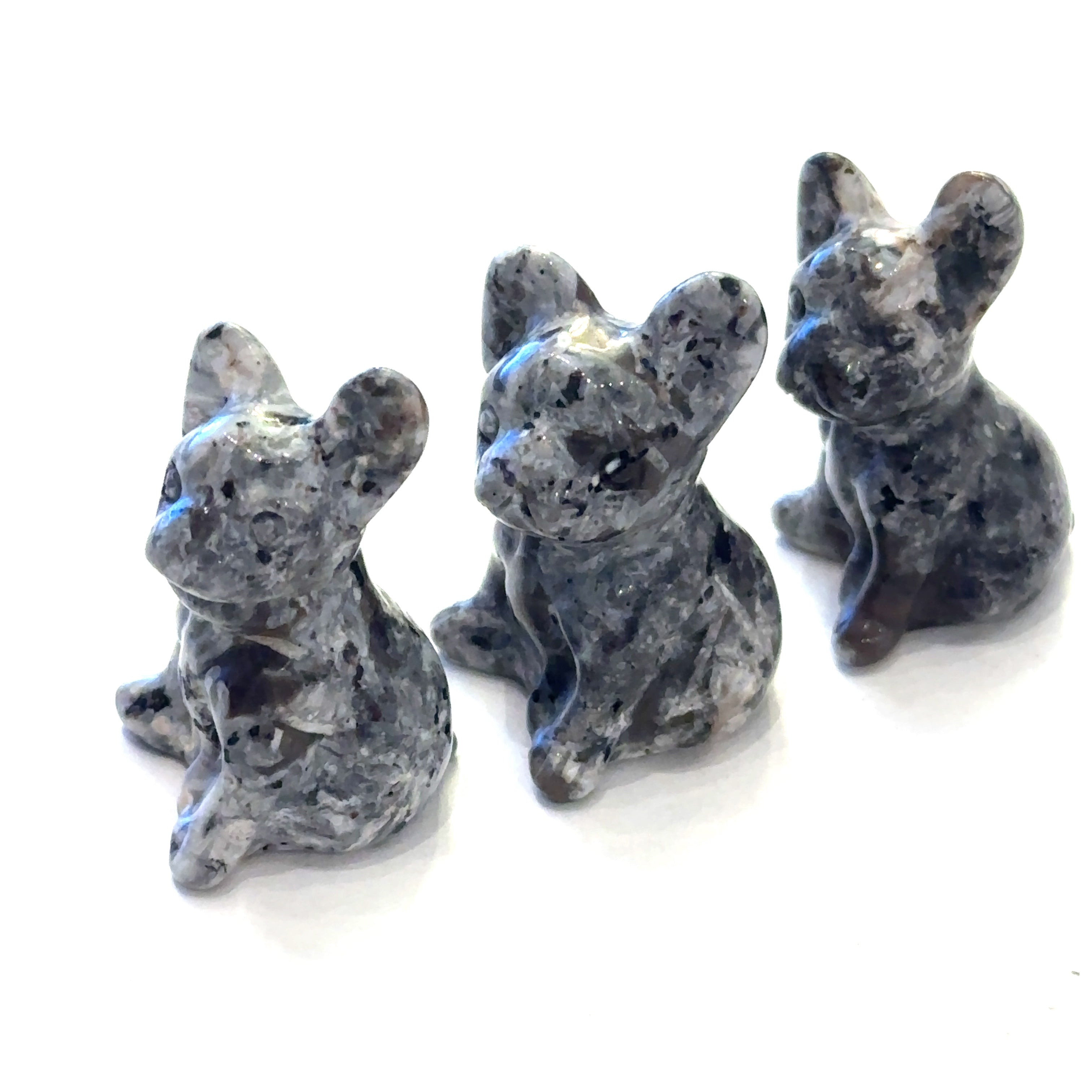 Three Moss Agate Bull Dogs gemstone carving on white background, front view. 