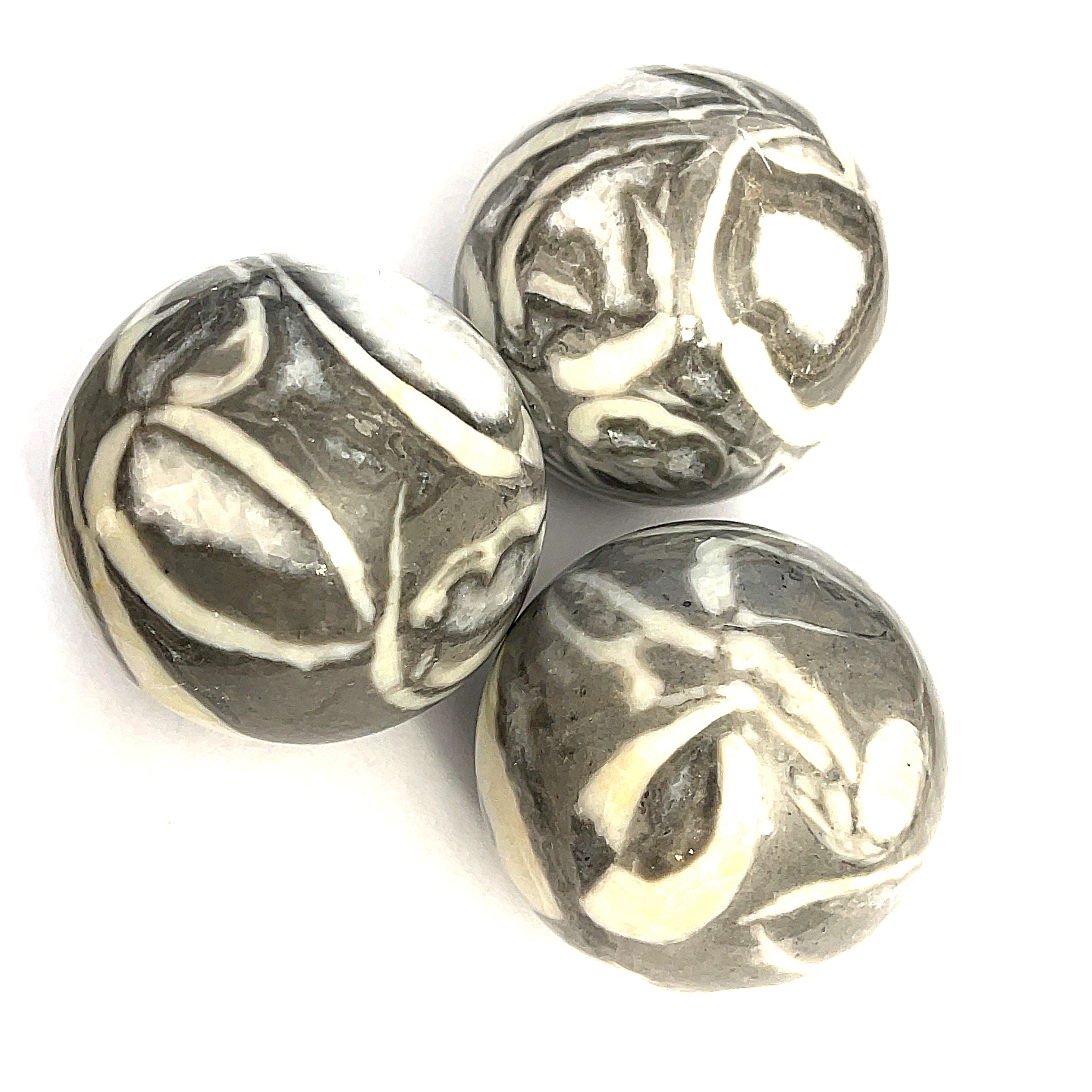 Three Shiva Shell Gemstone Spheres displayed on a white background, close-up front overview.