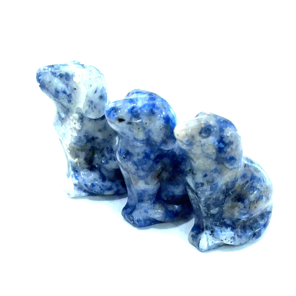 Three sodalite hound Dogs gemstone carving on white background, front view.