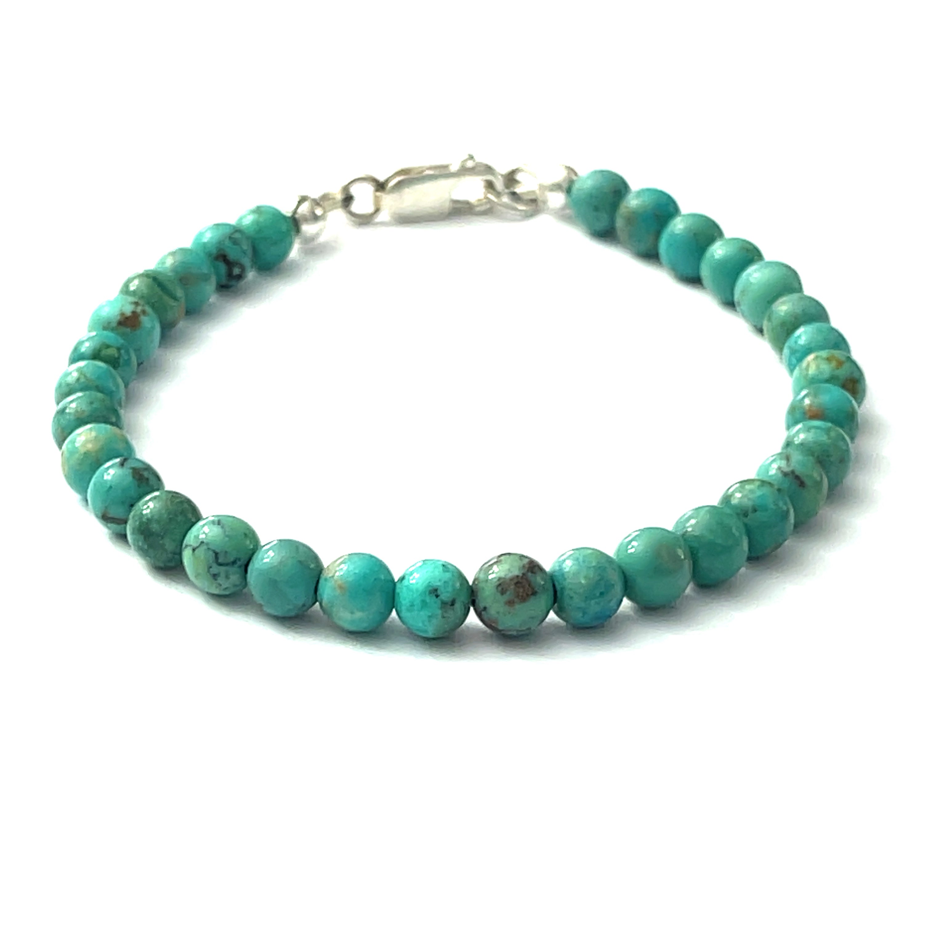 Top-grade Turquoise beads strung on durable Beadalon wire with a sterling silver lobster claw on a white background front view. 