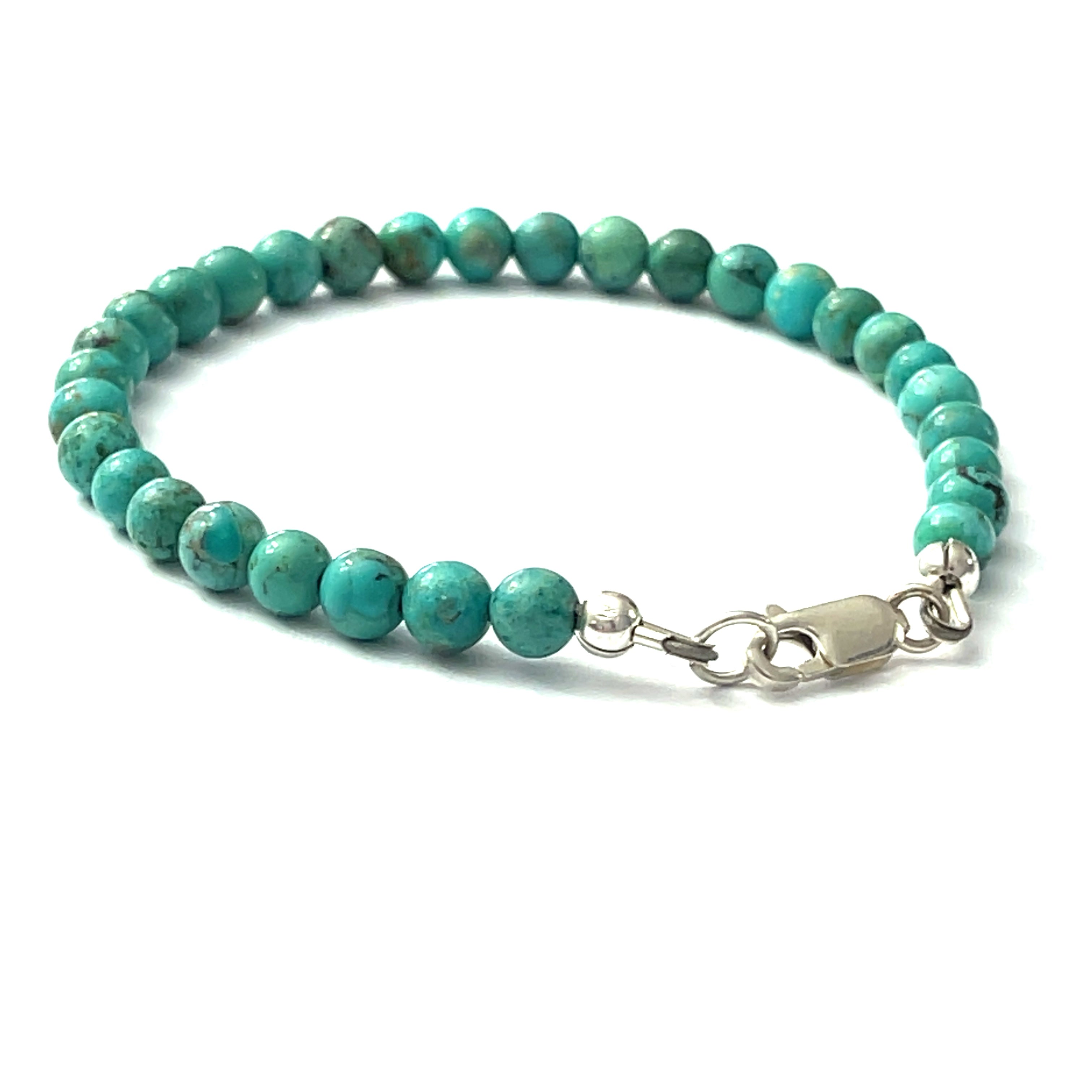 Top-grade Turquoise beads strung on durable Beadalon wire with a sterling silver lobster claw on a white background lobster claw view. 