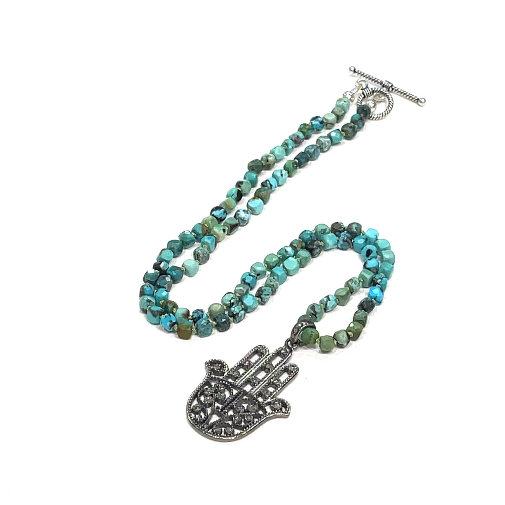 Turquoise gemstone knotted necklace with pave diamond Humza pendant handcrafted by Hidden Jewel of the South End n a white background center  overview