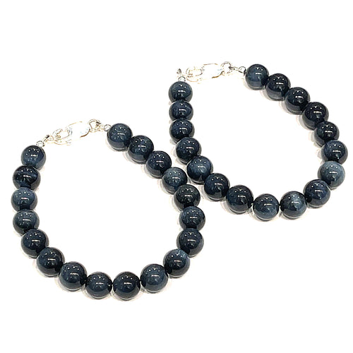 Two 8.5mm Blue Tiger Eye gemstone beaded bracelet with sterling silver lobster claw clasp showing deep midnight blue chatoyant bands on a white background, front view. 