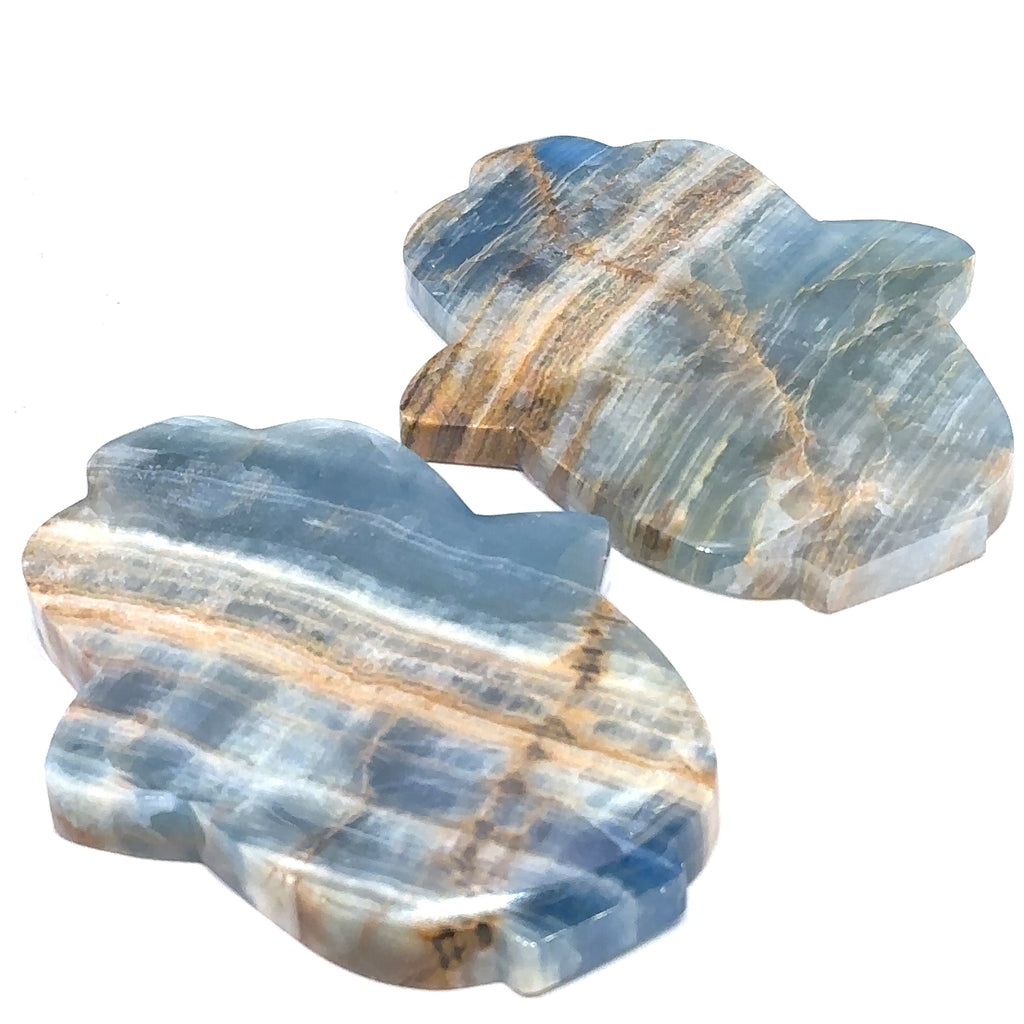 Two Blue Onyx gemstone carvings in a Hamsa shape with visible blue and white color patterns on a white background front overview