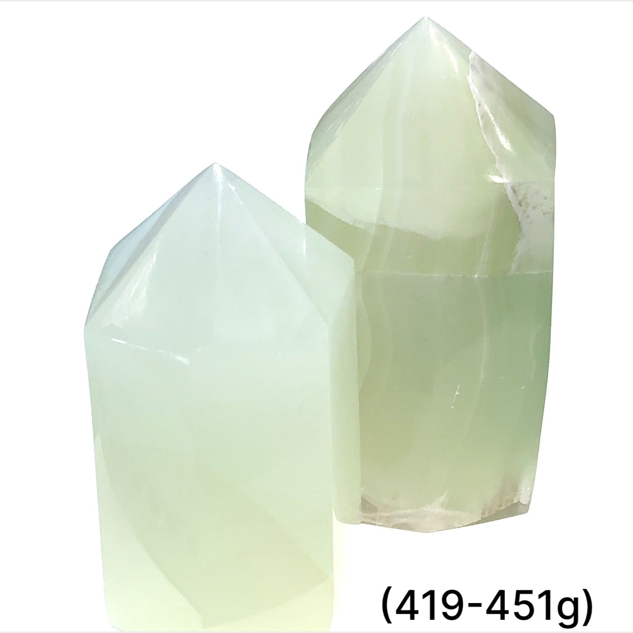 Two  green calcite gemstone towers (419-451g) on a white background, front overview.