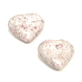 Two medium size Cinnabar gemstone heart displayed on a white background front, center, overview. 
