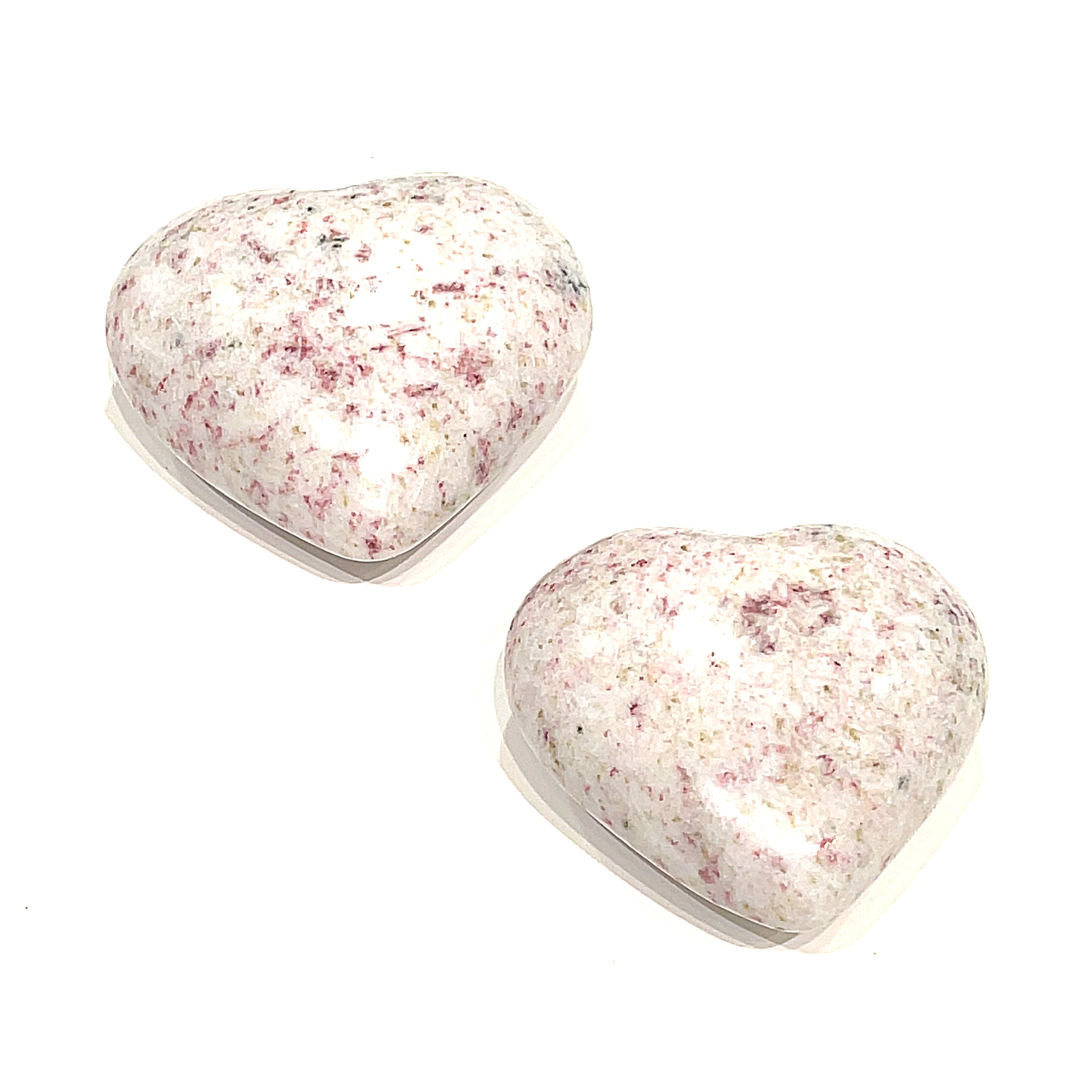 Two medium size Cinnabar gemstone heart displayed on a white background front, center, overview. 