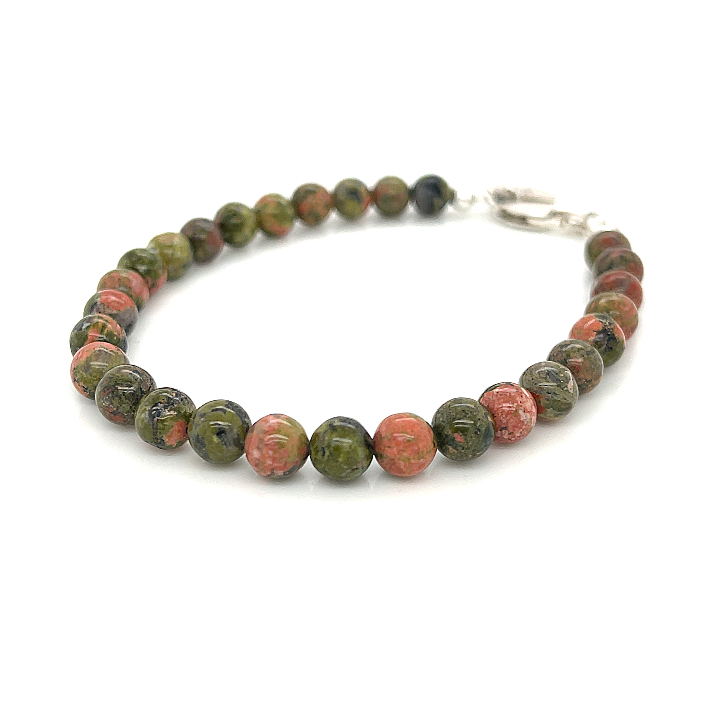Unakite beaded bracelet with 6mm smooth round gemstones and a sterling silver lobster claw clasp for gentle emotional healing on a white background, left angle view. 