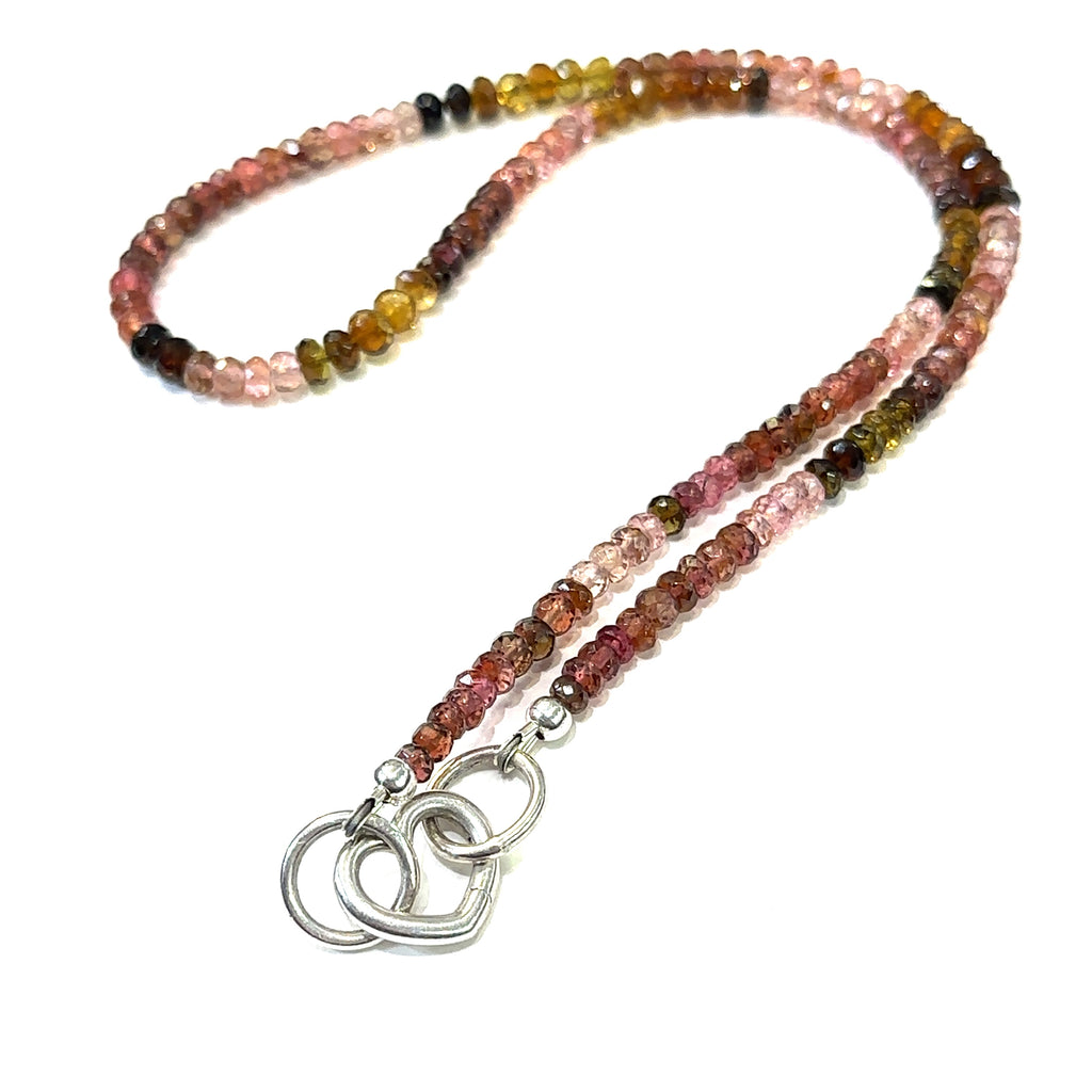Vibrant faceted Tourmaline gemstone necklace inspired by autumn garden colors on a white background long heart toggle overview.