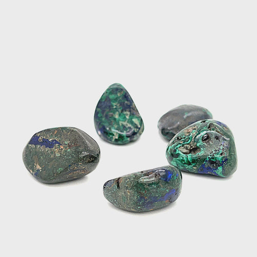 tumbled Azurite gemstone with visible Malachite inclusions on a white background, front view. video