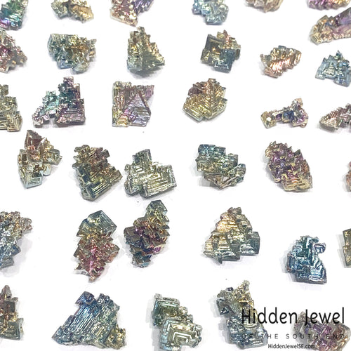 a grouping of bismuth gemstones on white overview