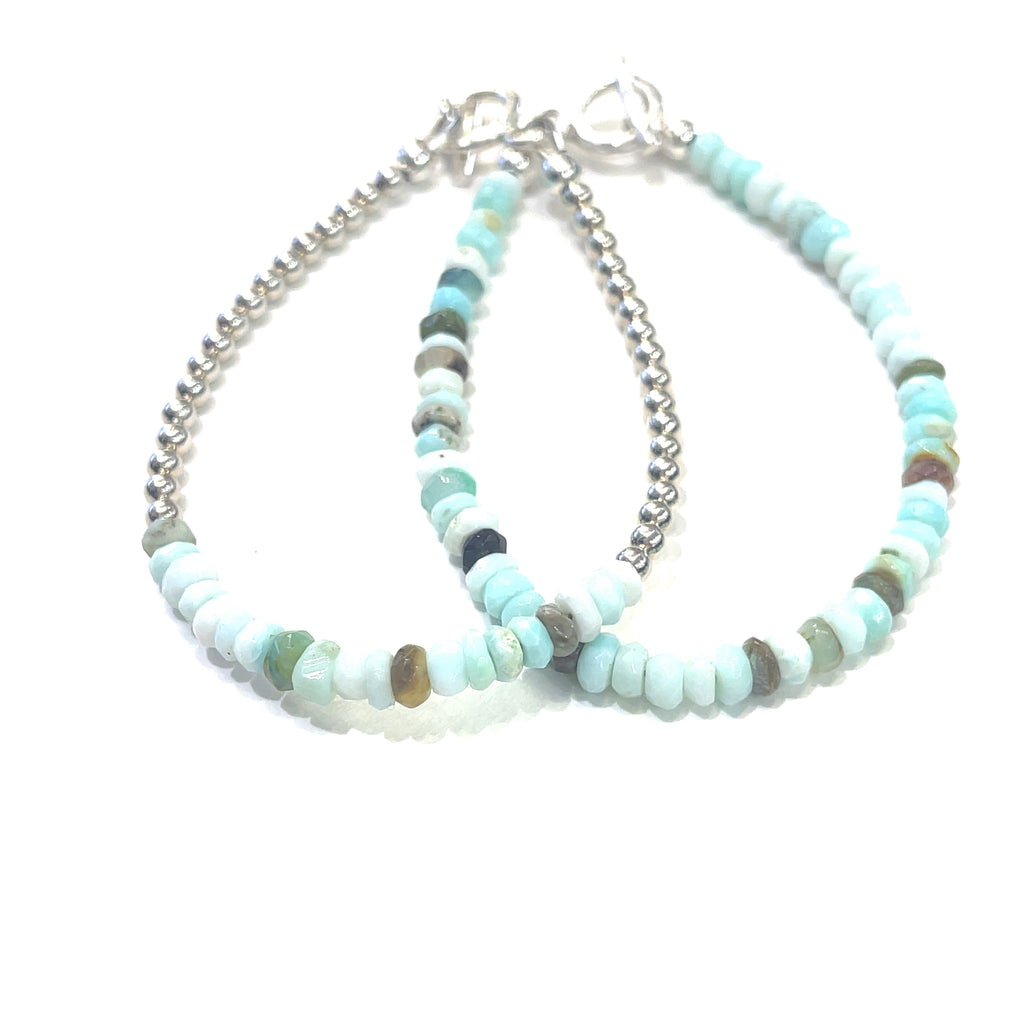 a set of two  Blue Opal gemstone bracelet with sterling silver toggle handmade by Hidden Jewel on a white background front and center overview.