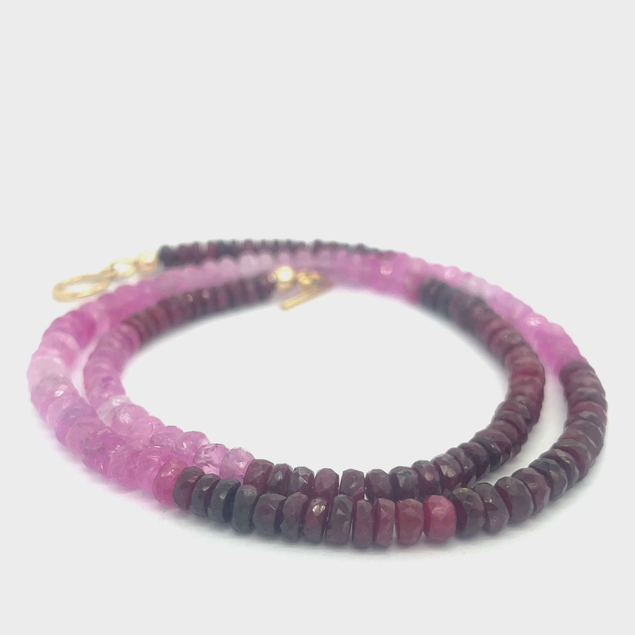 Genuine Ruby gemstone necklace with gold-filled toggle clasp by Hidden Jewel on a white background front, center spiral overview.