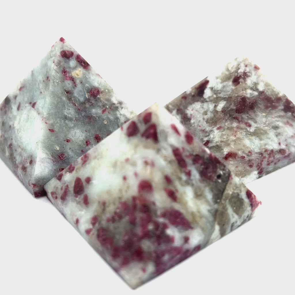 A Pink Tourmaline Pyramid used for heart chakra meditation and energy healing on a white background overview. viideo