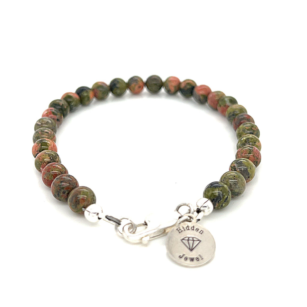 Unakite beaded bracelet with 6mm smooth round gemstones and a sterling silver lobster-claw clasp for gentle emotional healing, on a white background, front view.  video