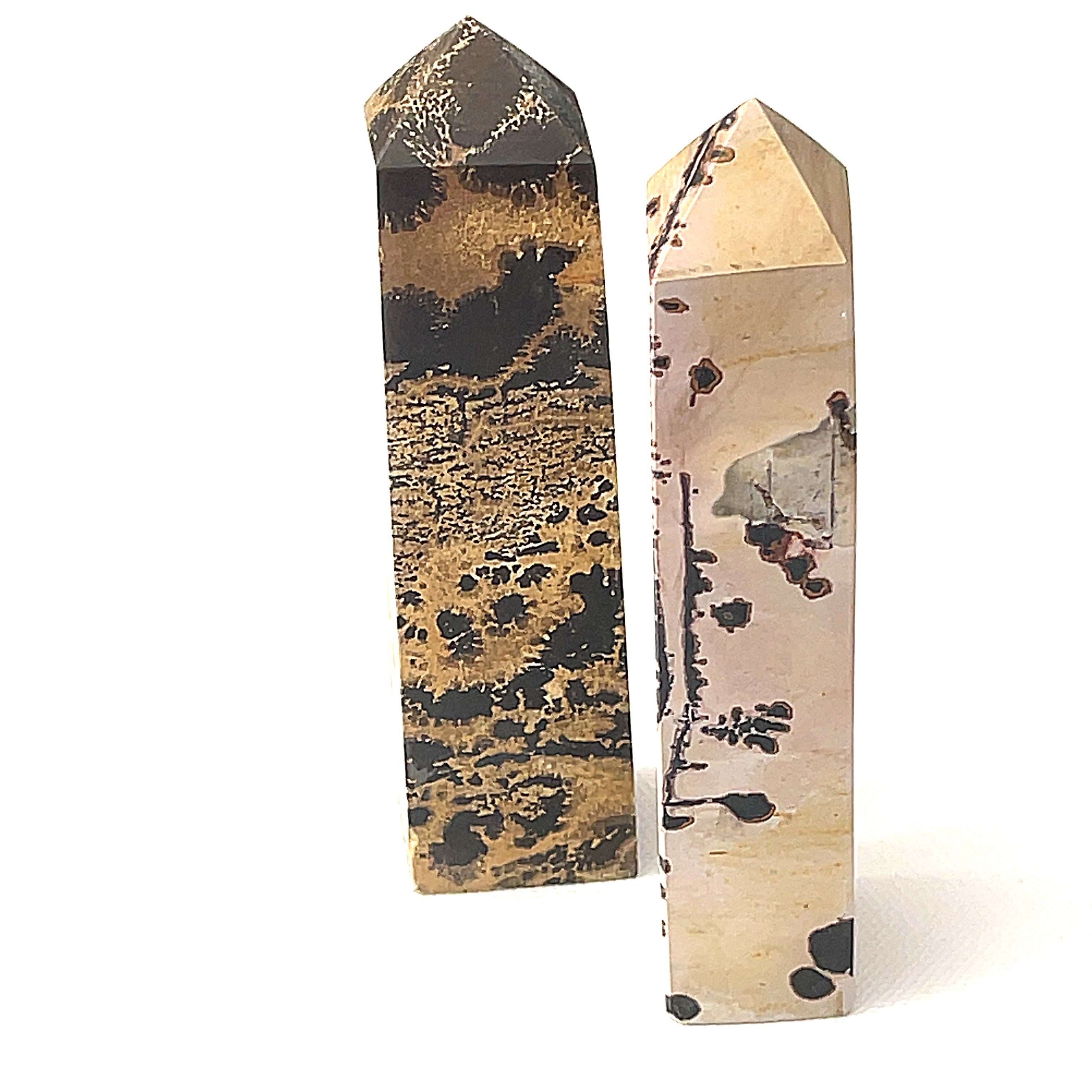 two different  Picture Jasper gemstone tower  on a white background, front view.